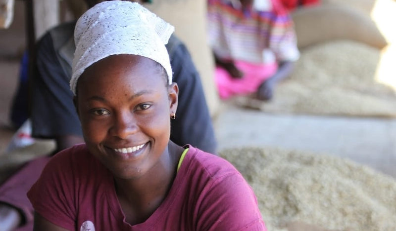 Young woman smiling in a casual setting with blurred background
